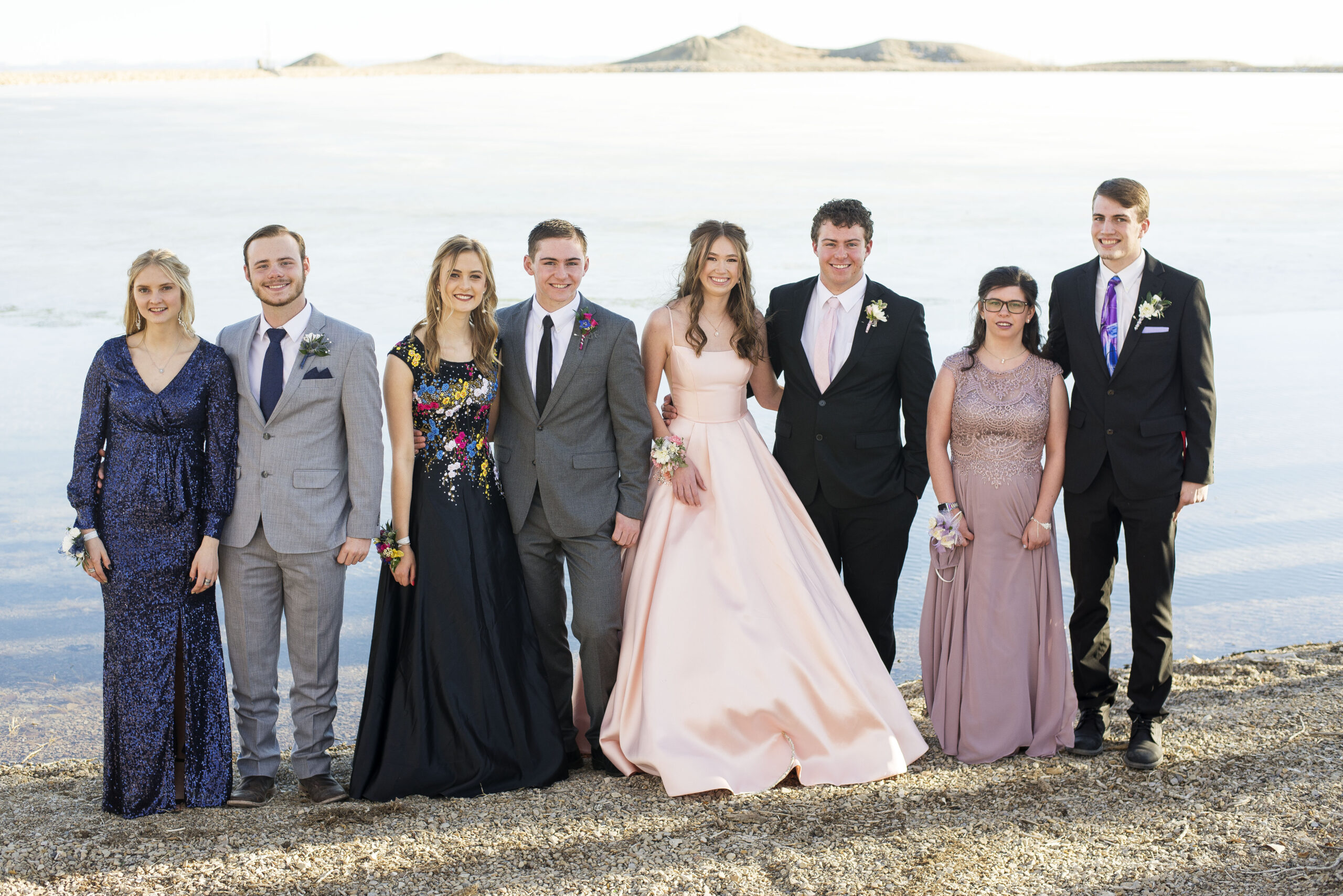 group of senior high schoolers pose for senior prom photos
